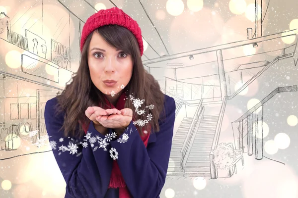 Festive brunette blowing over hands — Stock Photo, Image