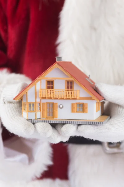 Santa holds tiny house in hands — Stock Photo, Image