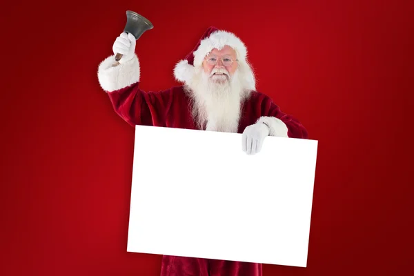 Weihnachtsmann hält Schild und läutet seine Glocke — Stockfoto