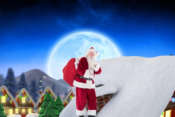圣诞老人在小屋的屋顶上 — 图库照片