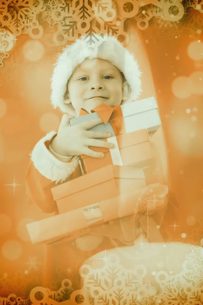 Složený obraz roztomilý chlapeček v santa kostým — Stock fotografie