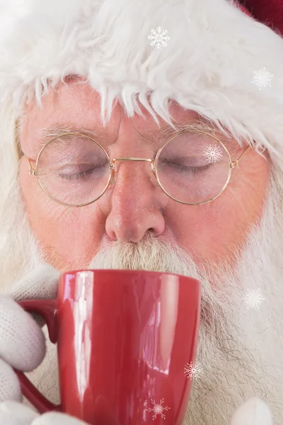 Santa drinks from red cup — Stock Photo, Image