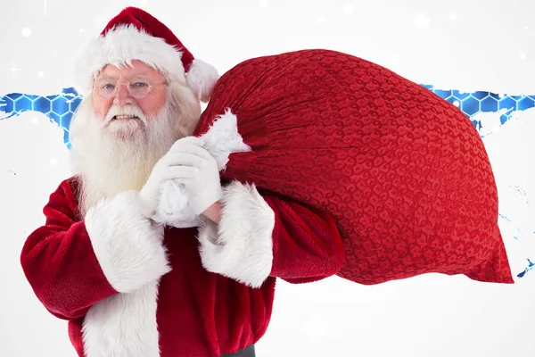 Santa carries his red bag and smiles — Stock Photo, Image