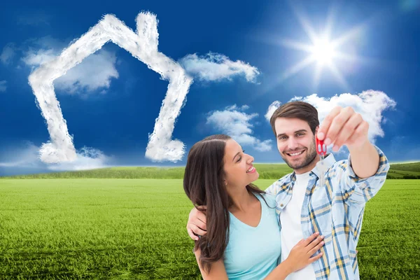 Happy young couple showing new house key — Stock Photo, Image