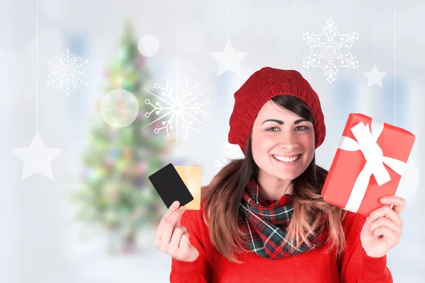 Brunette in red hat holding gift — Stock Photo, Image