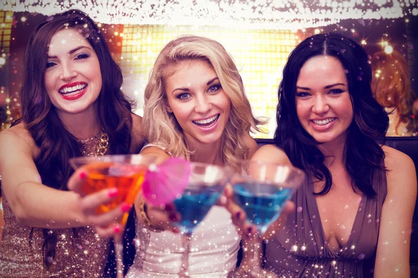 Composite image of pretty friends drinking cocktails together — Stock Photo, Image