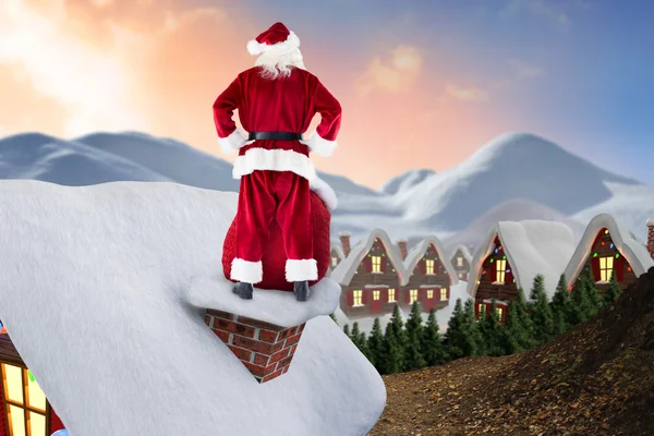 Santa on cottage roof — Stock Photo, Image