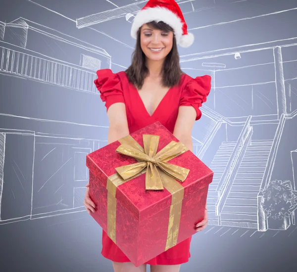 Festive brunette giving gift — Stock Photo, Image