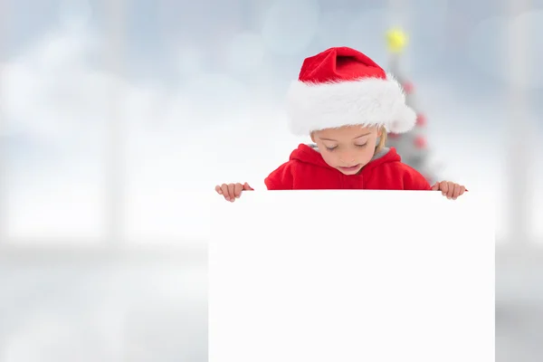 Composite image of festive little girl showing poster — Stock Photo, Image