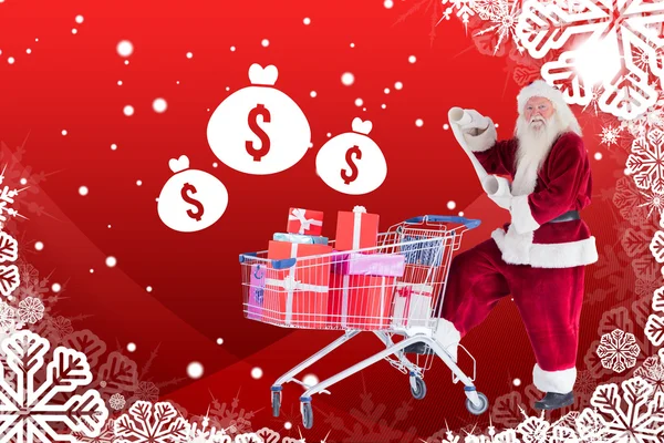 Santa empuja un carrito de compras mientras lee —  Fotos de Stock