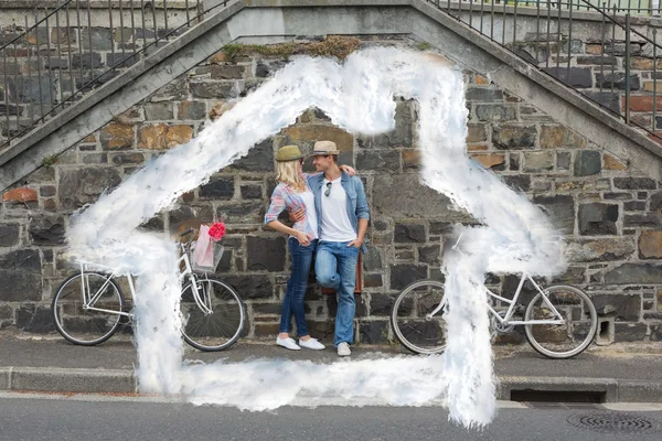 Et ungt par står ved murvegg – stockfoto