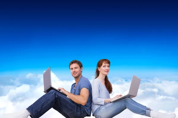 Couple both using laptops separately — Stock Photo, Image