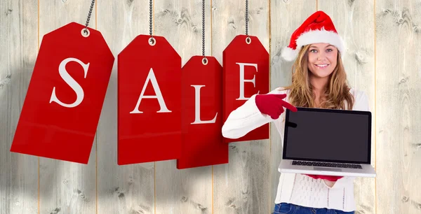 Festive blonde pointing to laptop — Stock Photo, Image