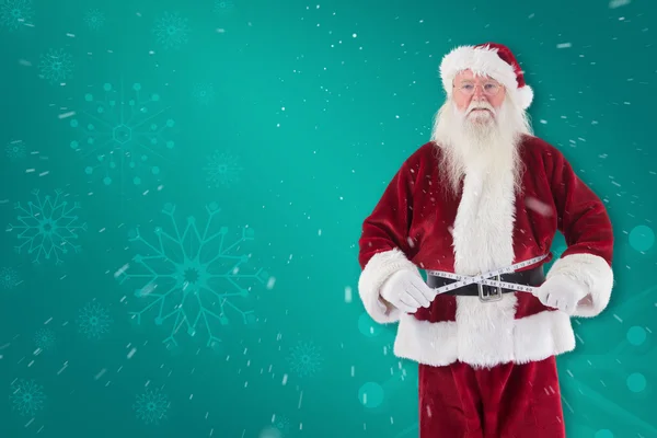 Санта Клаус измеряет свой живот — стоковое фото