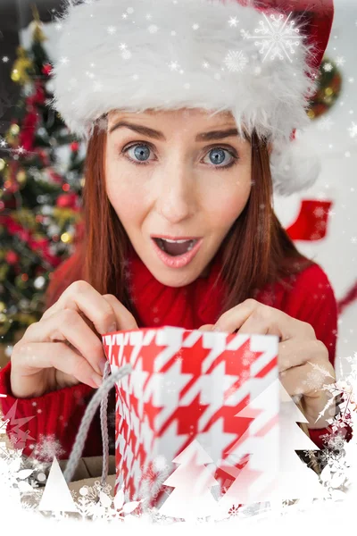 Festive redhead opening christmas gift — Stock Photo, Image