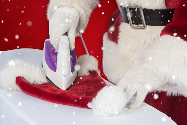 Julemanden stryger sin hat. - Stock-foto
