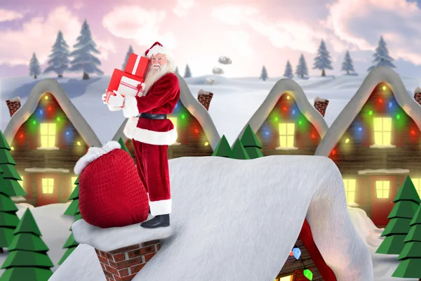 Santa on cottage roof — Stock Photo, Image