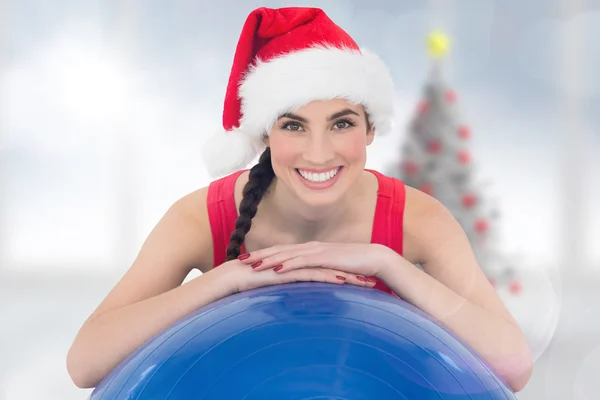 Festive fit brunette leaning on exercise ball — Stock Photo, Image