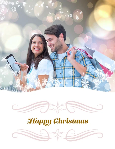 Composite image of happy couple with shopping bags — Stock Photo, Image