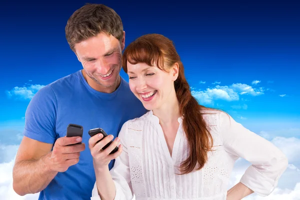 Couple using their mobile phones — Stock Photo, Image