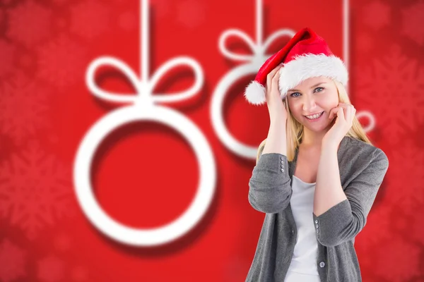 Composite image of festive blonde smiling at camera — Stock Photo, Image