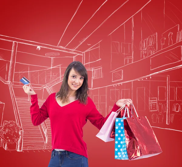 Brunette holding gift and credit card — Stock Photo, Image