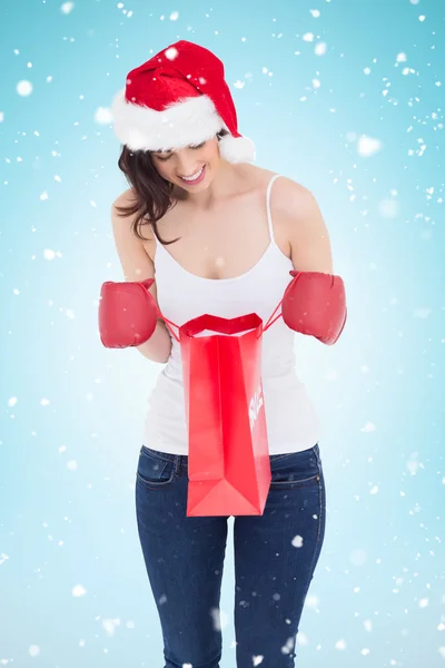 Brunette looking in shopping bag — Stock Photo, Image