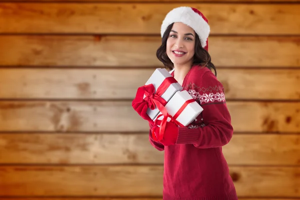 Imagem composta de morena alegre segurando presentes de Natal — Fotografia de Stock