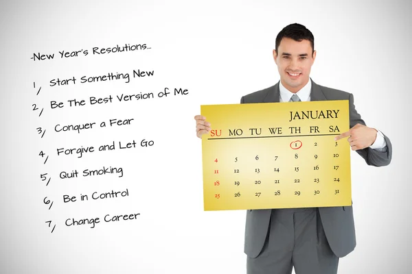 Businessman pointing at calendar — Stock Photo, Image