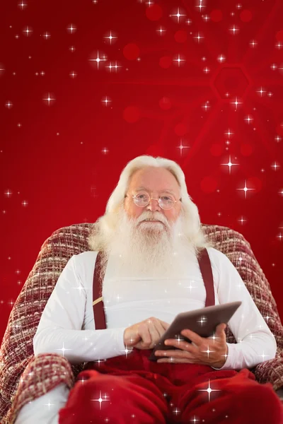 Smiling santa using tablet — Stock Photo, Image