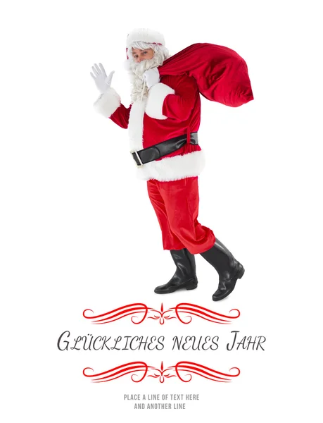 Santa holding a sack and waving — Stock Photo, Image