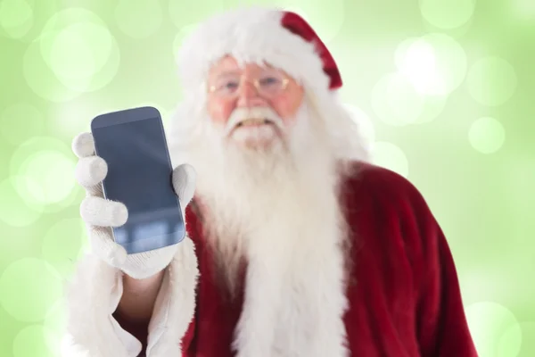 Santa Claus pokazuje smartphone — Zdjęcie stockowe