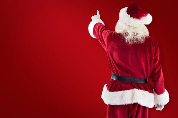 Santa Claus punten op iets — Stockfoto