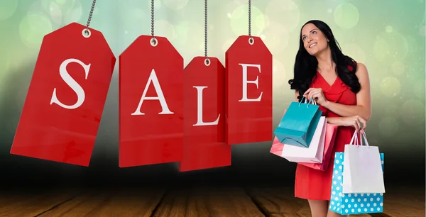 Woman standing with shopping bags — Stock Photo, Image