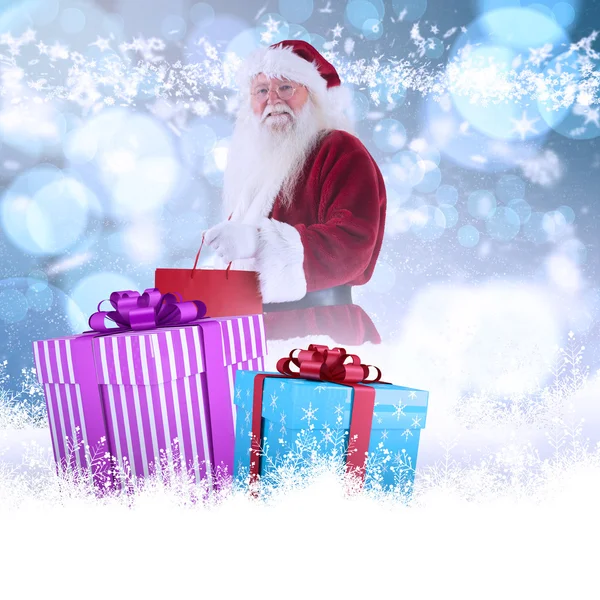 Santa carries red gift bag — Stock Photo, Image