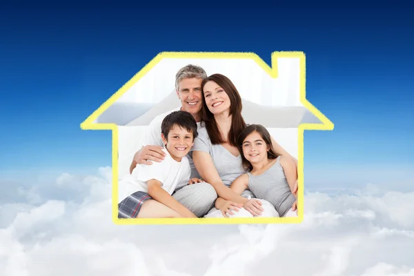 Family sitting on a bed — Stock Photo, Image