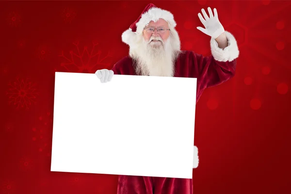 Weihnachtsmann hält Schild und winkt — Stockfoto