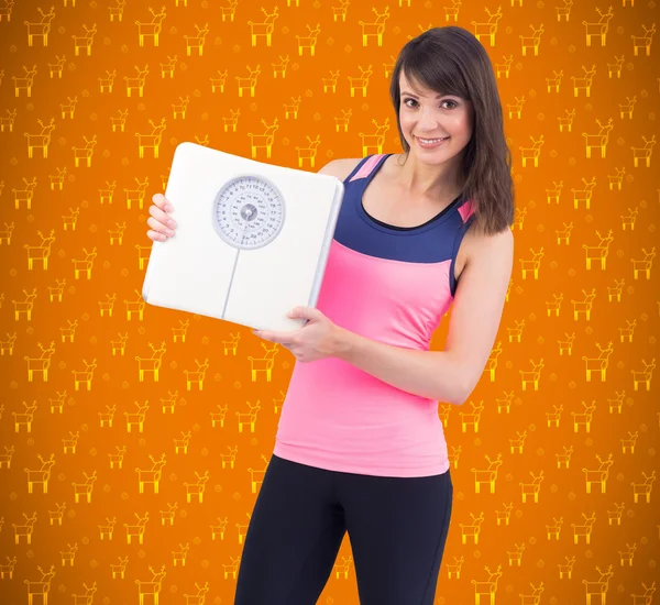 Smiling woman holding weighing scales — Stock Photo, Image