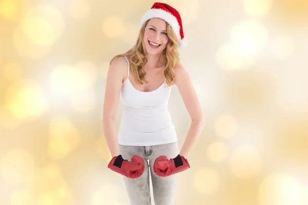 Kompositbild einer festlichen Blondine mit Boxhandschuhen posiert — Stockfoto
