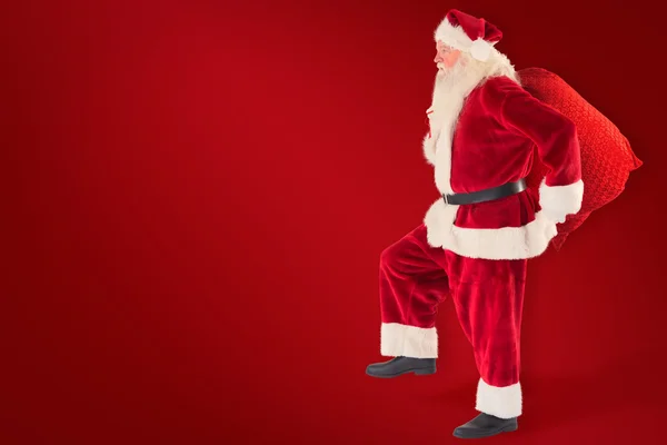 Santa jumps with his bag — Stock Photo, Image