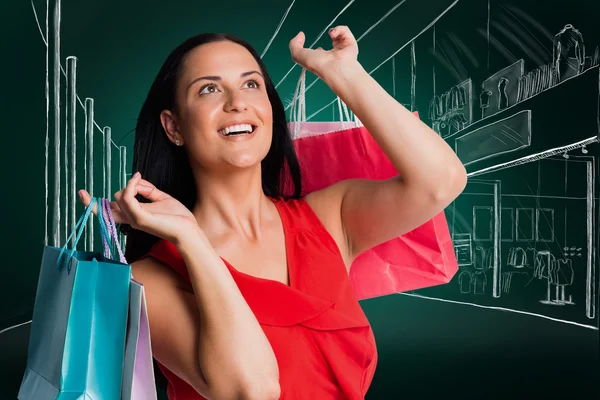 Mujer de pie con bolsas de compras — Foto de Stock