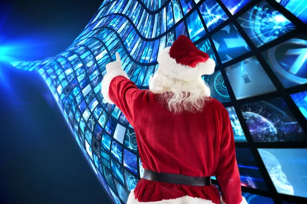 Samengestelde afbeelding van santa claus punten op iets — Stockfoto