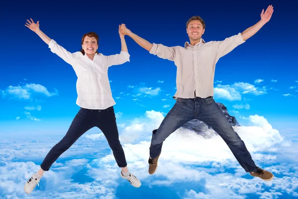 Couple jumping and holding hands — Stock Photo, Image