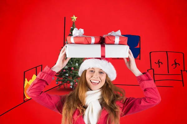 Festive redhead holding pile of gifts — Stock Photo, Image