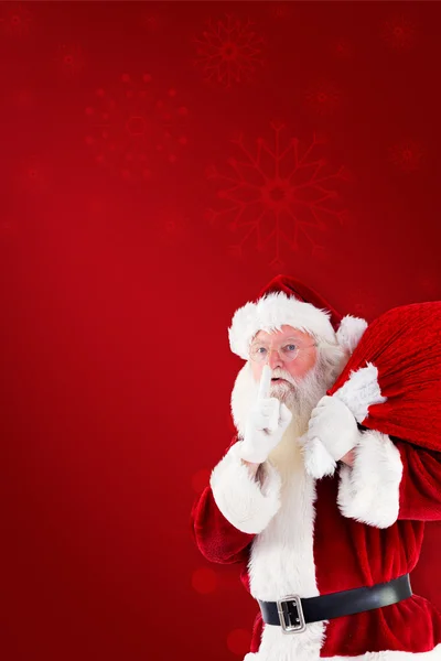 Santa claus carrying sack — Stockfoto