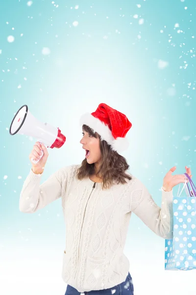 Brunette holding megaphone and bags — Stock Photo, Image