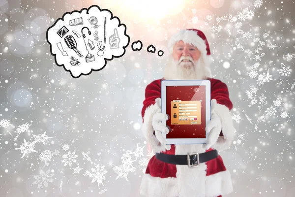 Weihnachtsmann präsentiert einen Tablet-PC — Stockfoto