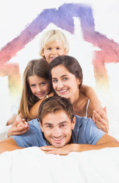Composite image of father giving piggy back to his family — Stock Photo, Image