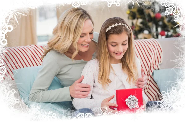 Daughter opening christmas gift with mother — Stock Photo, Image