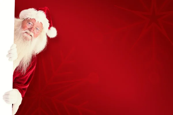 Babbo Natale guarda fuori dietro un muro — Foto Stock